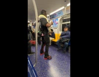 Man dances and kisses snake inside train