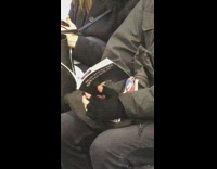 Man reads book called Sexting Ghosts on subway train
