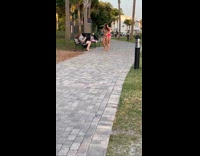 Grey shirt girl bench two bikini girls 