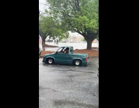 Guy drives green tiny car on road