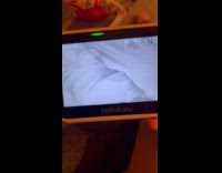 Mom checks twins on baby camera 