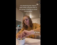 Girl yellow shirt eating chips and dip