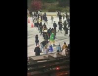 Man green robe ice skate on rink