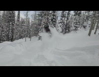 Guy rides red snowmobile flips over fail