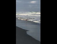 woman struggles to get on water ski