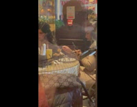 Woman takes a picture of her food inside restaurant