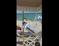 Pink bikini girl crawls towards friend beach
