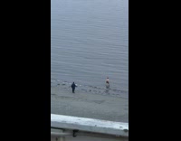 Man shirtless poses at the beach shore