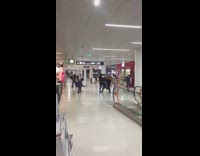 Four guys face masks airport dance 