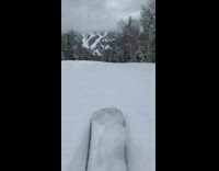 POV ski foot cloudy mountain snow trees
