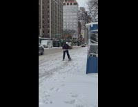 Guy riding electric scooter on snow in street