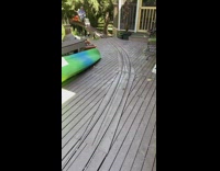 Ridable miniature train drives to the deck with a man and a little girl