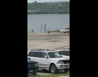 Police enforcer on the motorcycle poses by the river