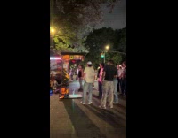 Men around the punching bag arcade machine