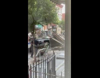 Tow truck tows black car debris window 