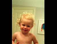 Kid sees reflection on glass at bathroom