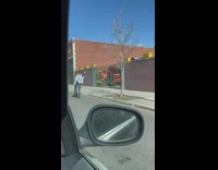 Guy riding bicycle puts ball on head