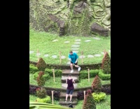 Guy do toy tricks rice fields statue