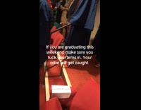 Students robe stuck at railings during graduation