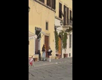 Two women with a dog tiktok dance beside the window