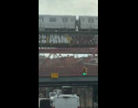 Passengers walk through stopped train on bridge