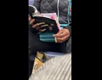 Woman with long nails read book subway