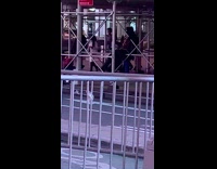 Guy costume mask sits scaffolding bar exercises 