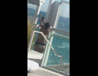 Girl on rooftop pool taking picture of ice cream