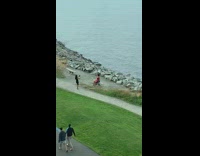 Girl red dress sit on bench lake