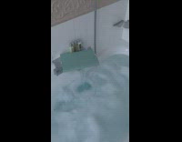 Woman draws bath and opens french doors