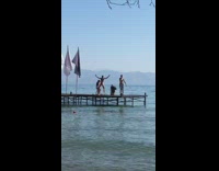 Three people tiktok dance beach dock boat arrives