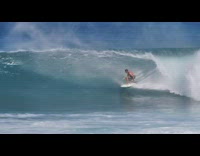 Surfer surfs big wave on white surfboard at beach