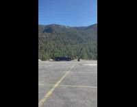 Man take photo convertible car helipad mountain