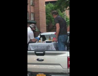 Two guys set up table outside restaurant 