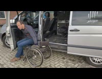 Guy gets into minivan with wheelchair lift