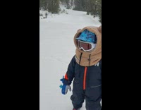 Little kid does ski jump off a ramp