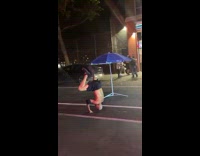Bald guy does head stand and does knuckle push ups on street