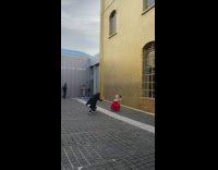 Lady wearing long red dress poses outside