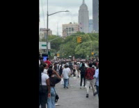 People on riot riding on top of taxi 