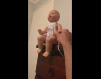 Toddler cheers when dad knocks toy down 