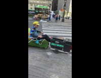 Guys in mario kart outfits riding motor lawn chairs