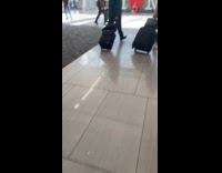 Woman red dress poses heart logo signage