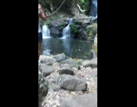 Woman blue top hand stand waterfalls pictorial