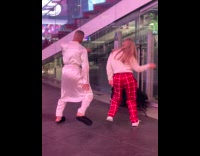 Man and Woman tiktok dance outside store