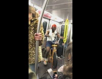Man orange durag rides bicycle workout machine on subway train
