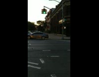 Three cars and orange cone block street