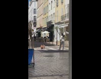 Girl posing in street photographer lays down