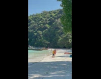 Woman with gloves messed with by beach monkeys