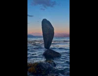 Rock balanced on another rock at beach