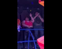 Woman dances to music in amusement ride